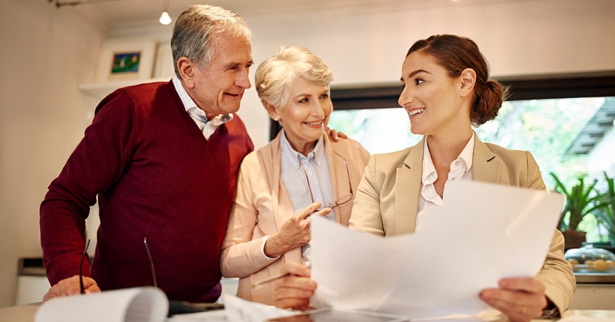 senior couple consulting female finance advisor