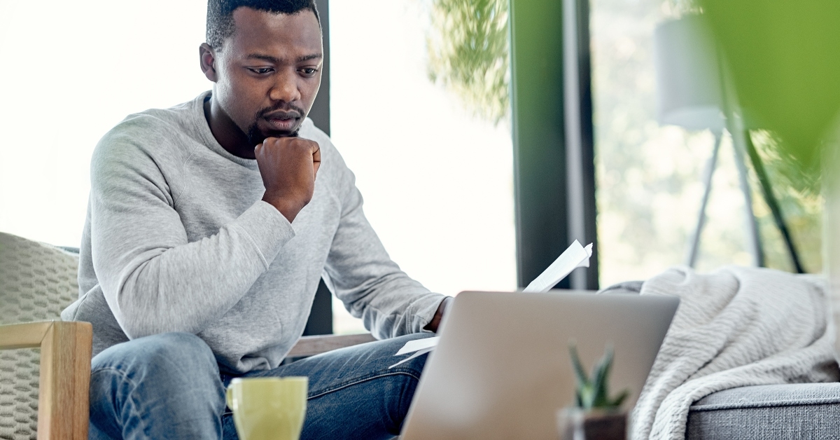 worried black man paying bills