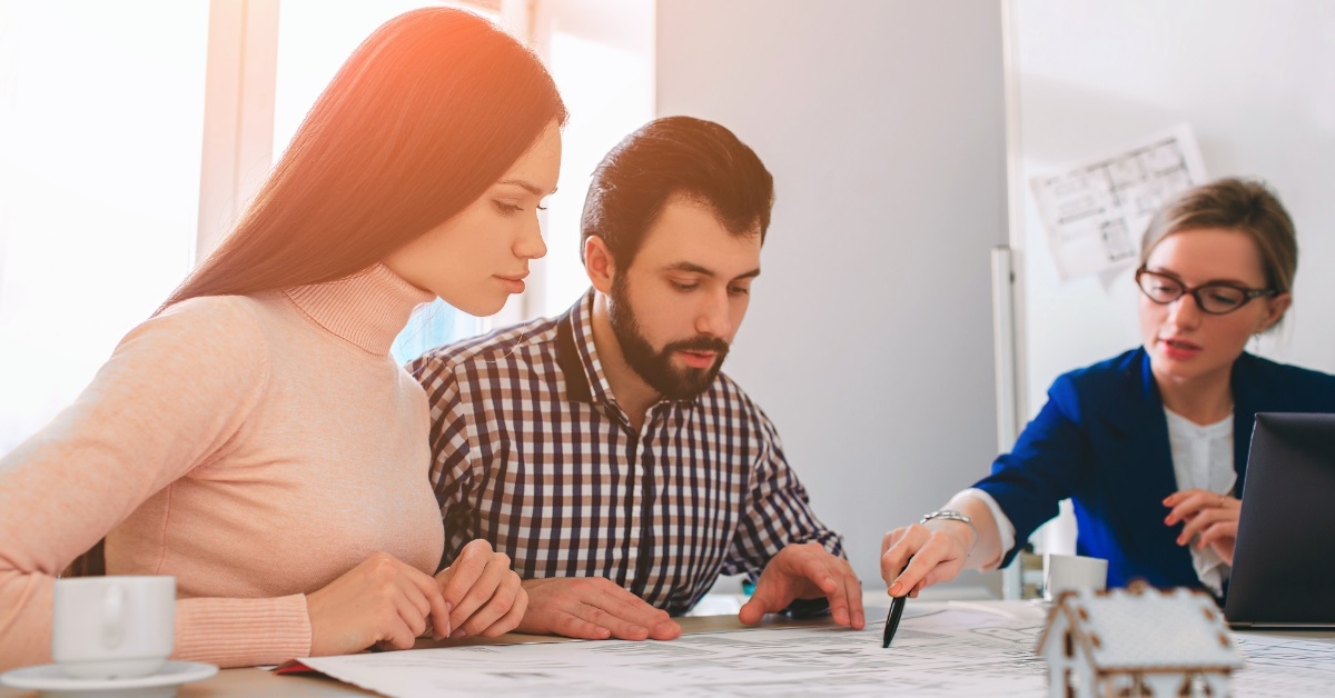 couple with female real estate agent