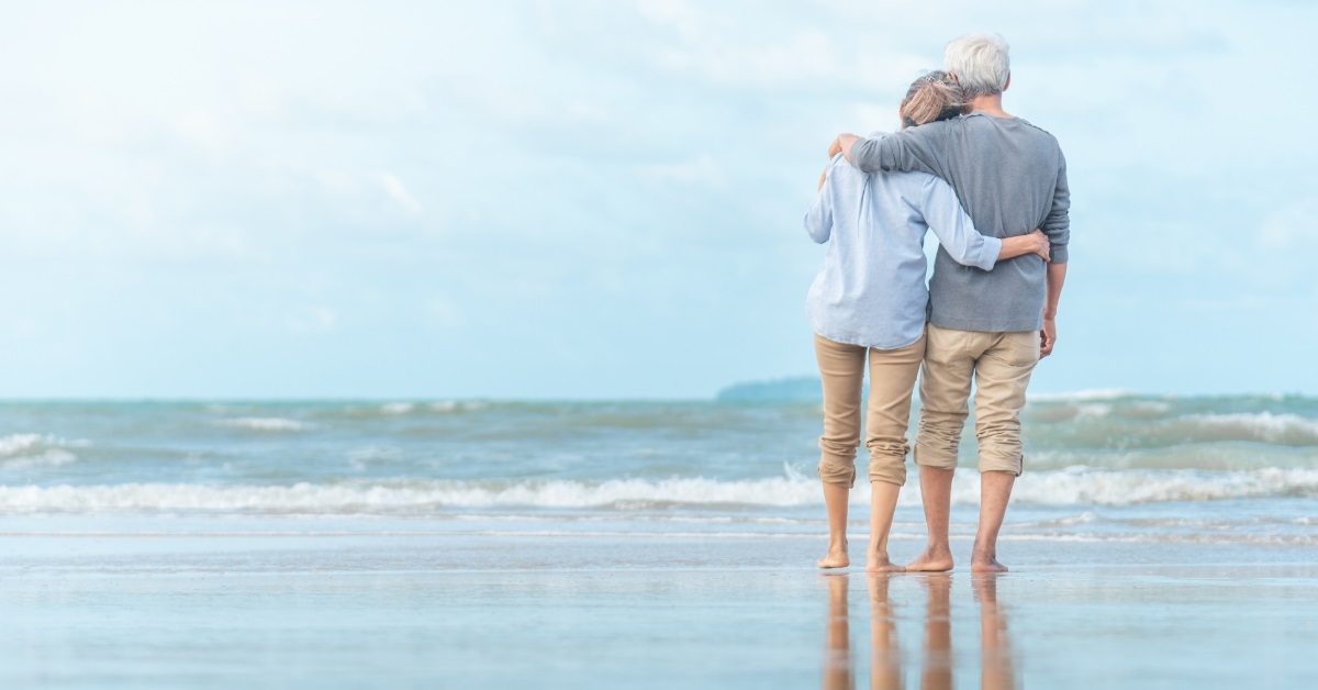 senior couple hugging at beach
