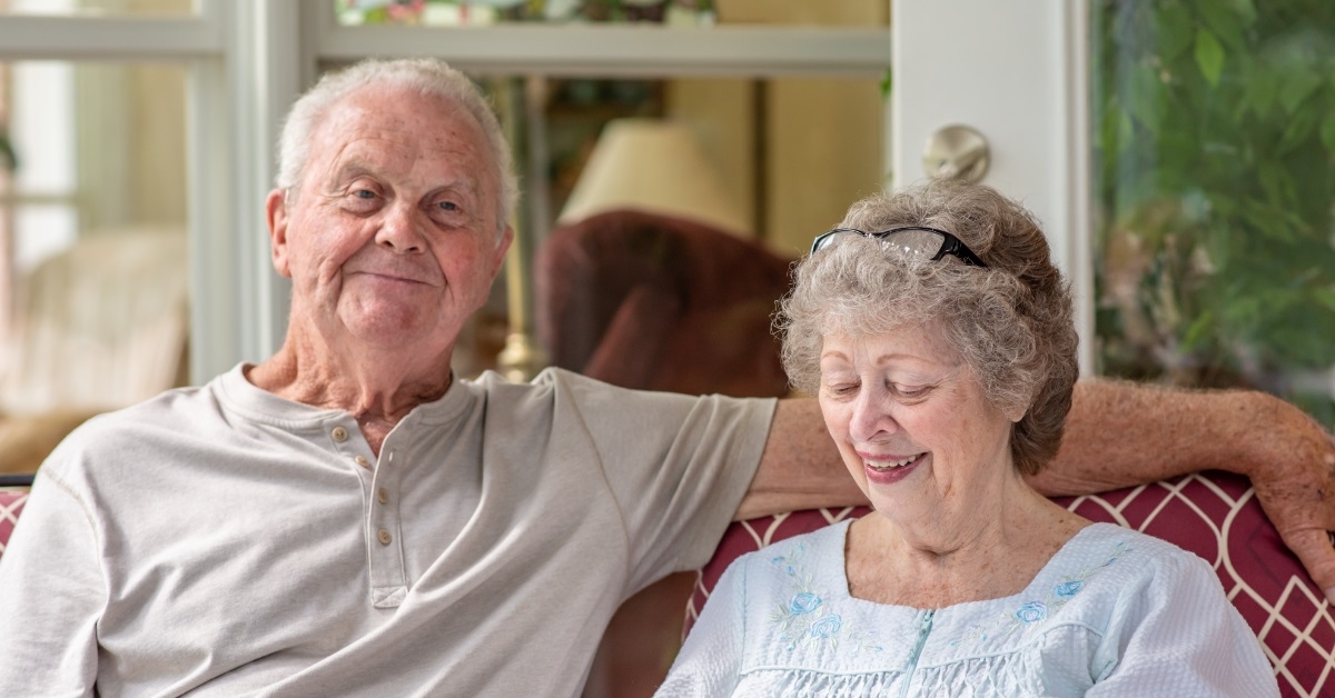 happy senior couple relaxing on couch