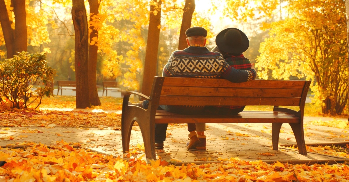 senior couple relaxing on park bench