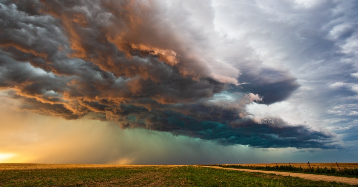 storm clouds over green field