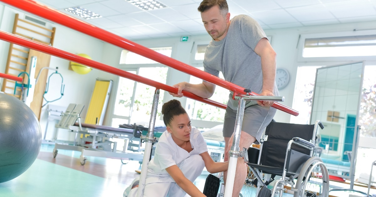 occupational therapist helping patient to walk