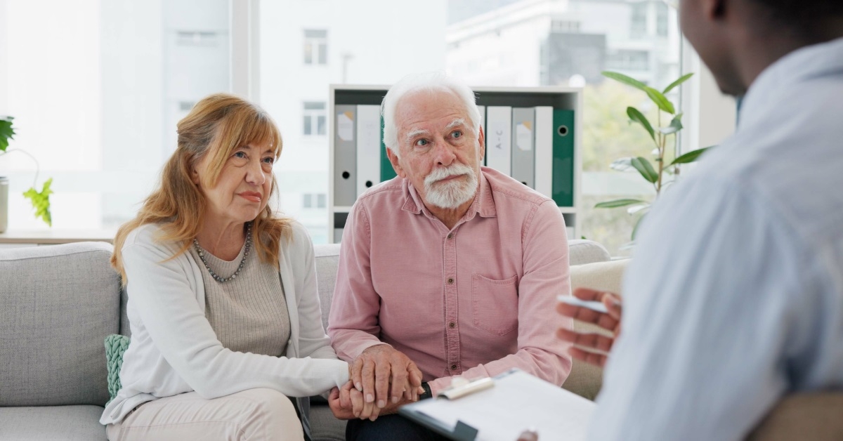 senior couple with therapist at clinic
