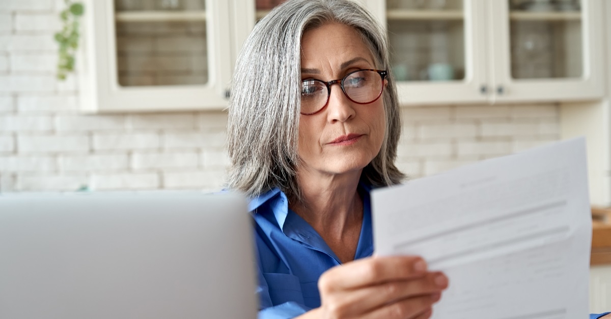 senior woman reviewing bills at home