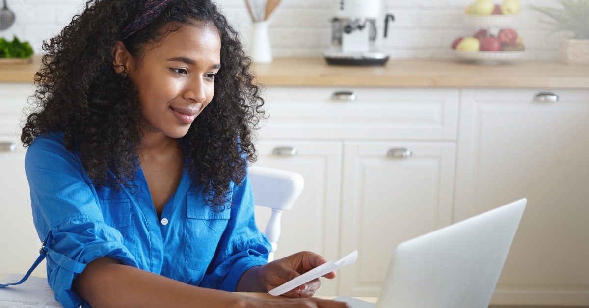 woman checking bills using laptop