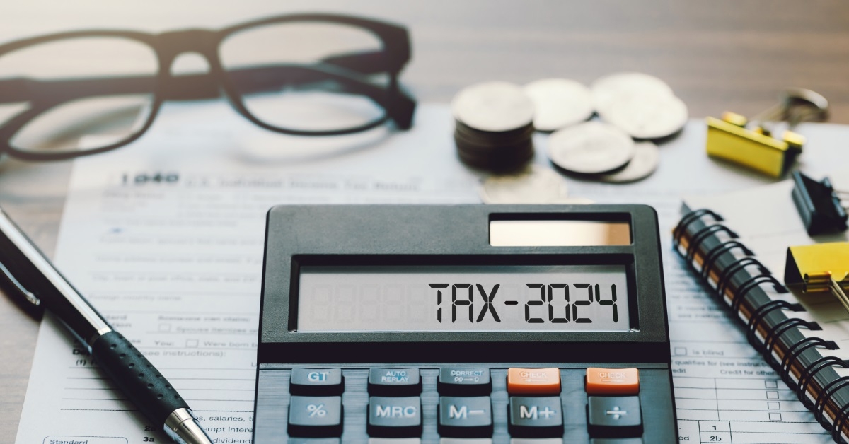 Tax 2024 on calculator with pennies