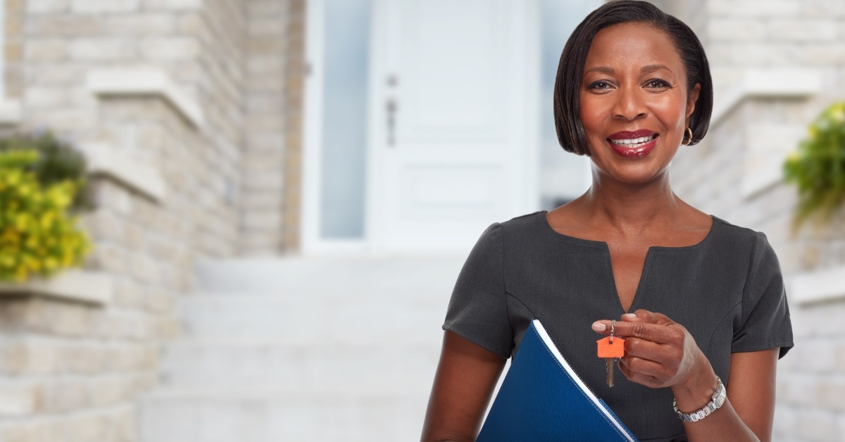 african american realtor holding keys outdoor