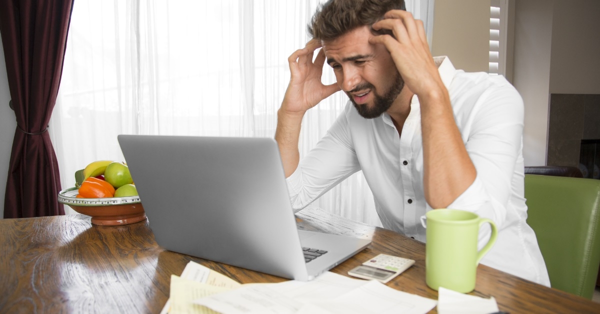 angry man doing taxes at home