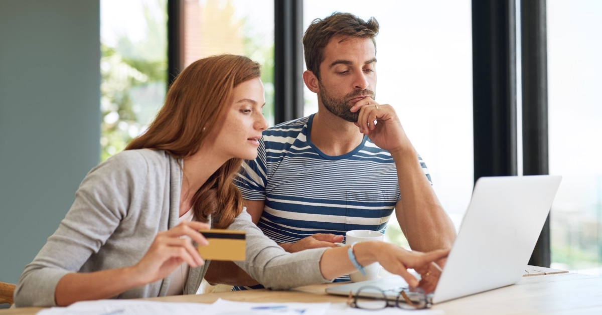 couple reviewing budget together using laptop