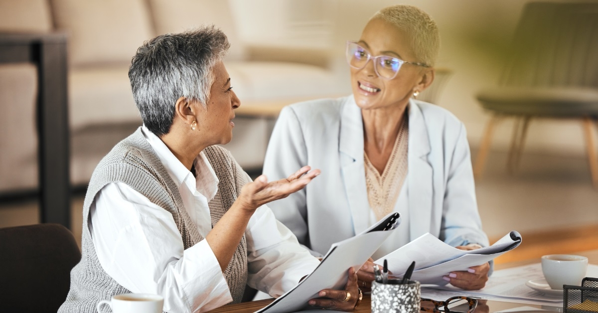 female colleagues discussing work at office