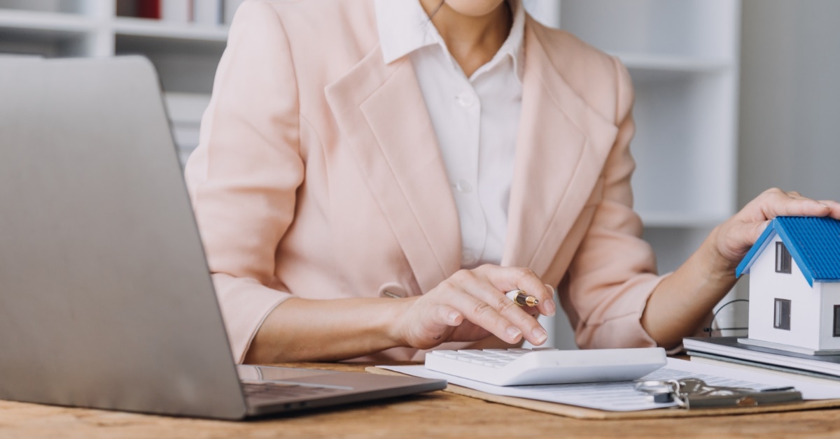 female realtor at work using laptop