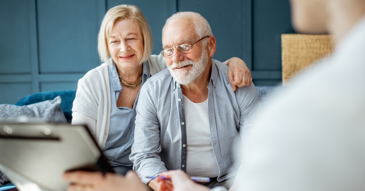 happy senior couple consulting finance advisor