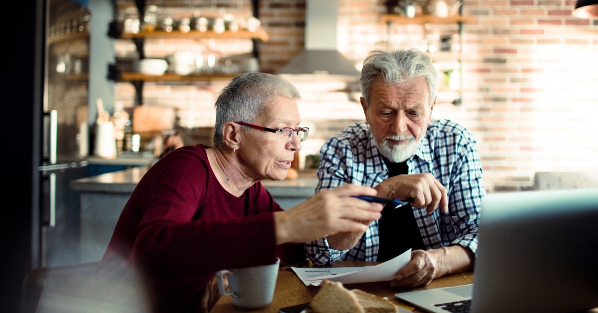 senior couple reading bills at home