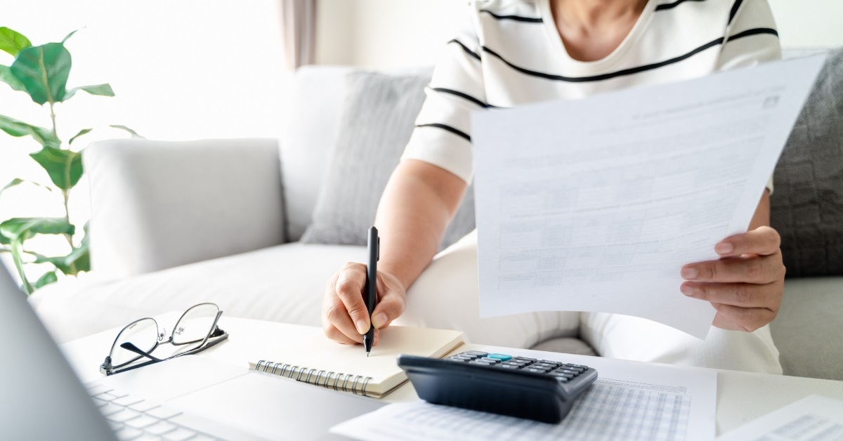 woman calculating annual tax with calculator