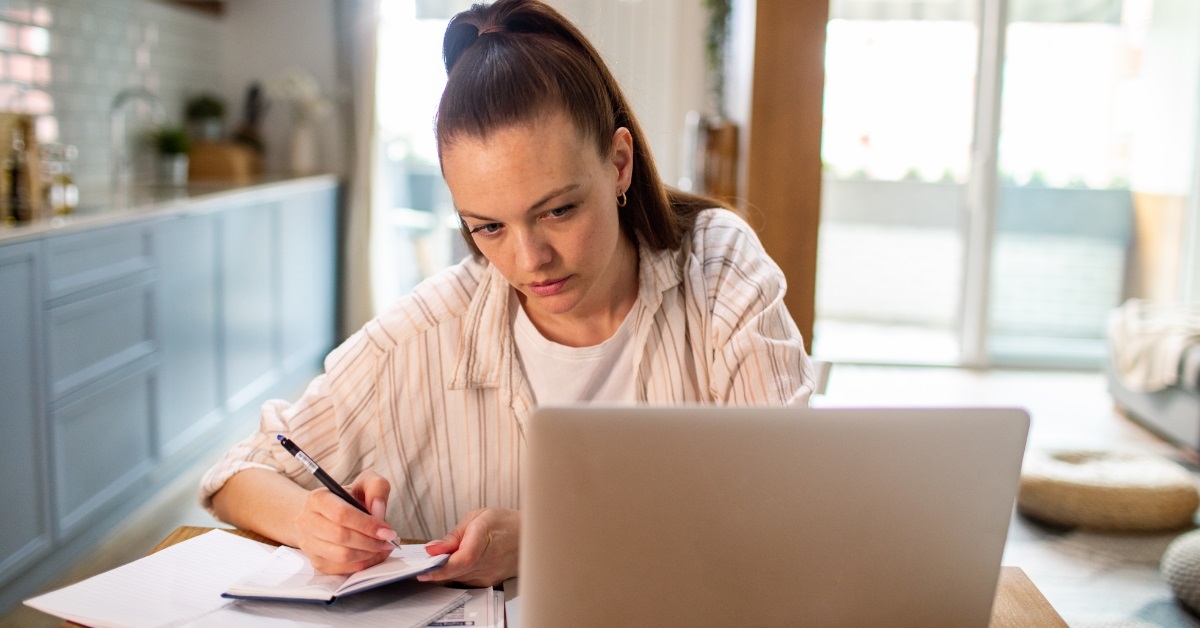 woman reviewing bills using laptop