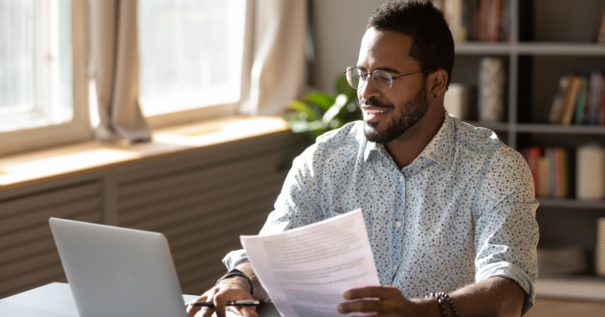 happy businessman using laptop at work