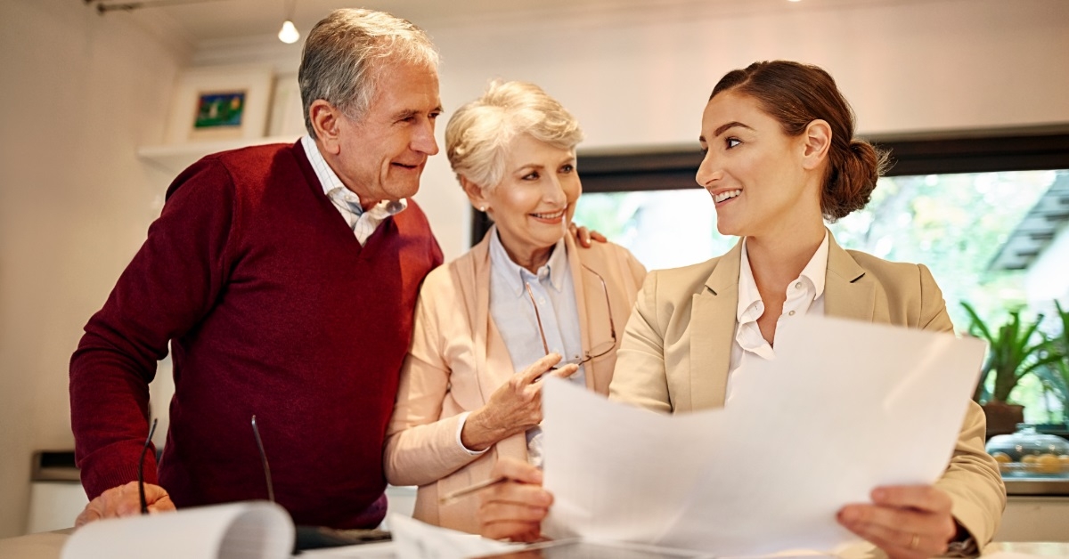 senior couple consulting female lawyer