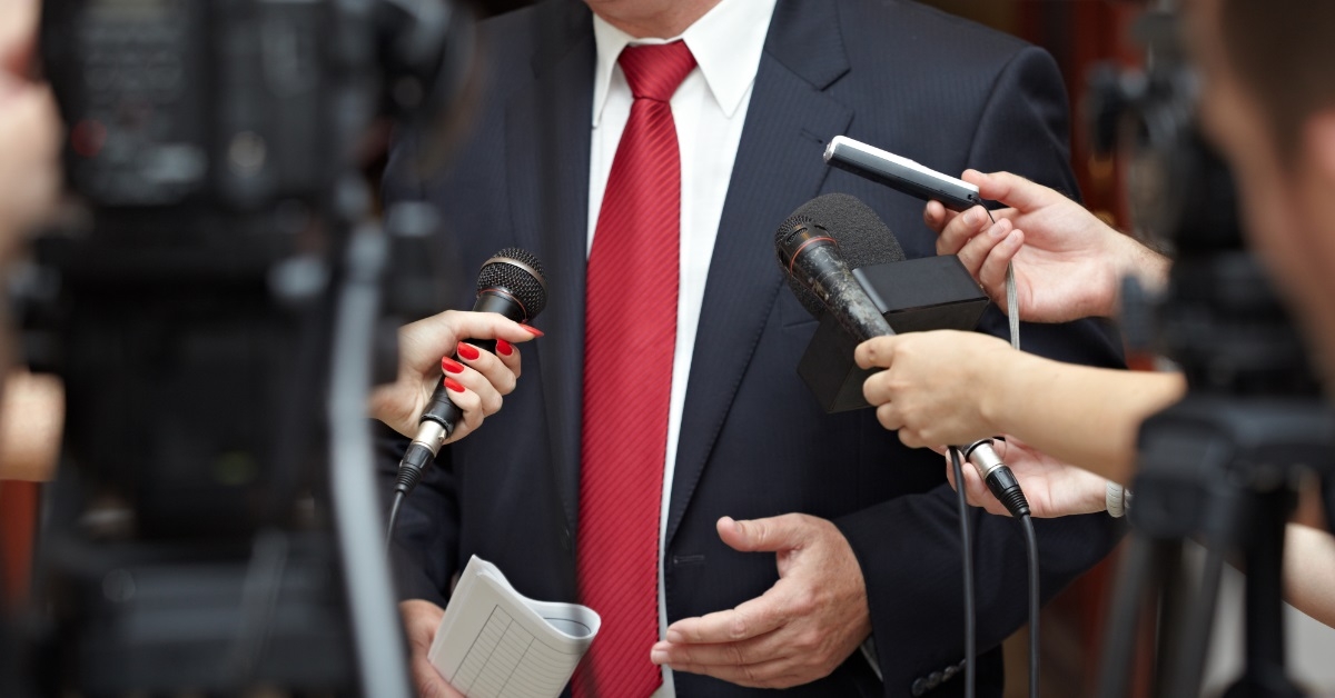 businessman speaking to journalists