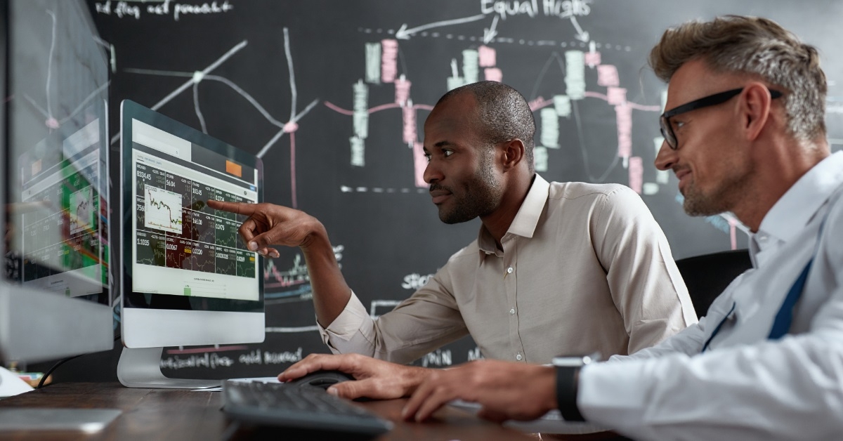 male brokers reviewing stocks together