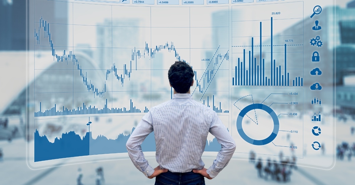 male trader reviewing stock market graphs