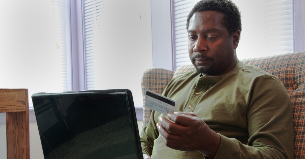 african american man shopping using laptop