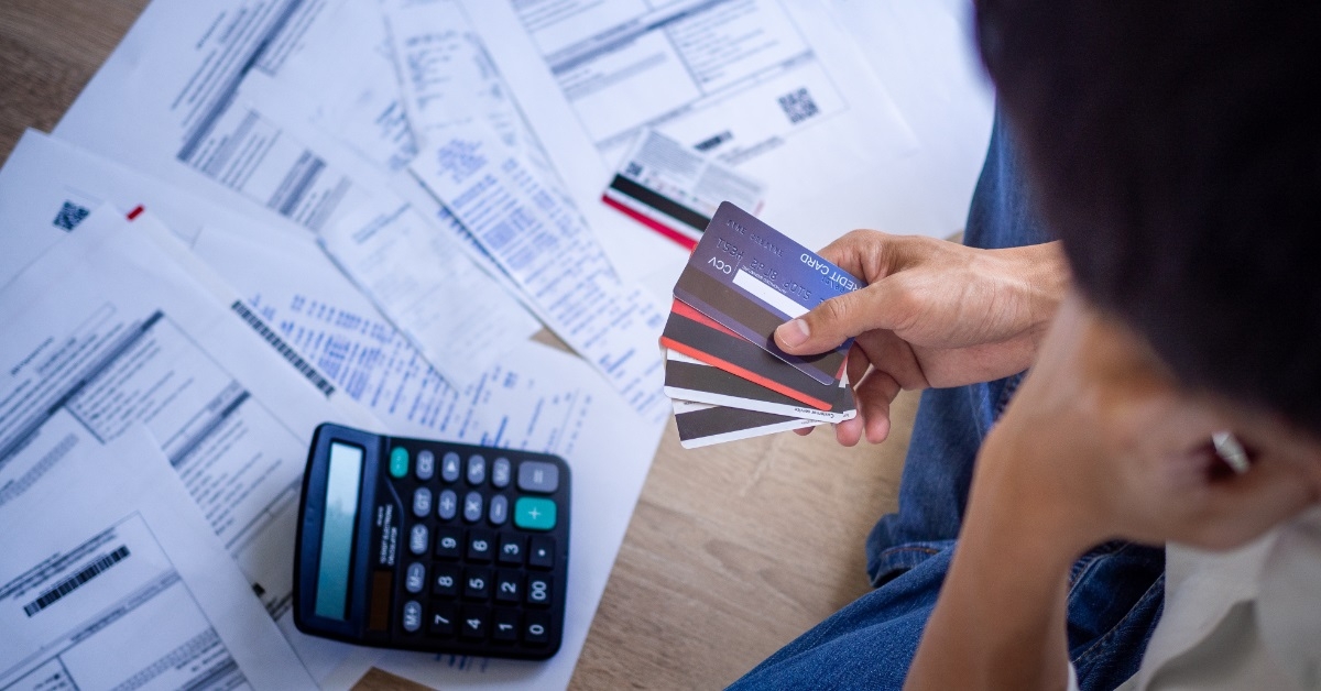 businessman choosing card to pay bills