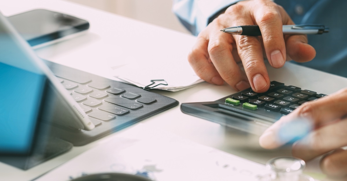 man calculating healthcare cost using calculator