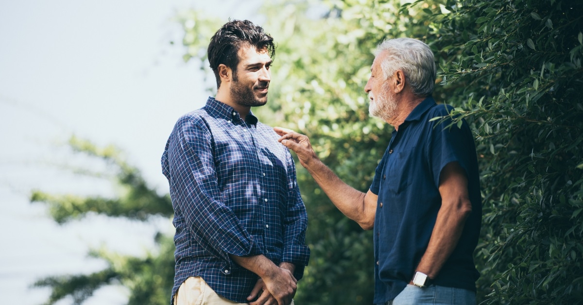 father giving advice to son outdoors
