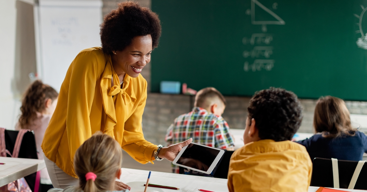 black teacher and elementary students