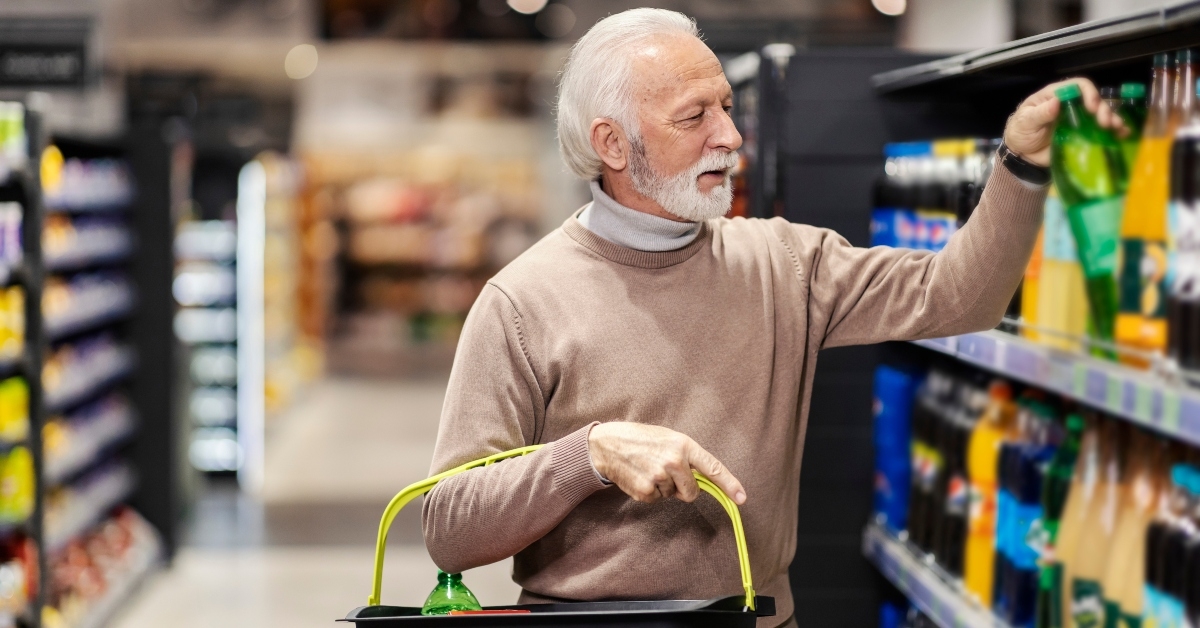 senior man buying soda