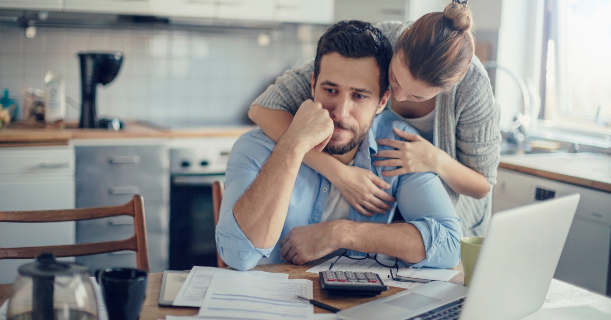 upset couple paying bills