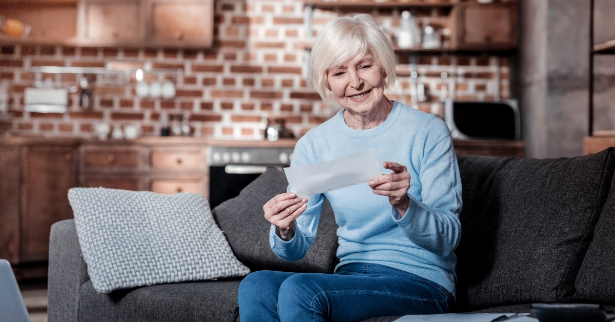 female pensioner reviewing bills at home