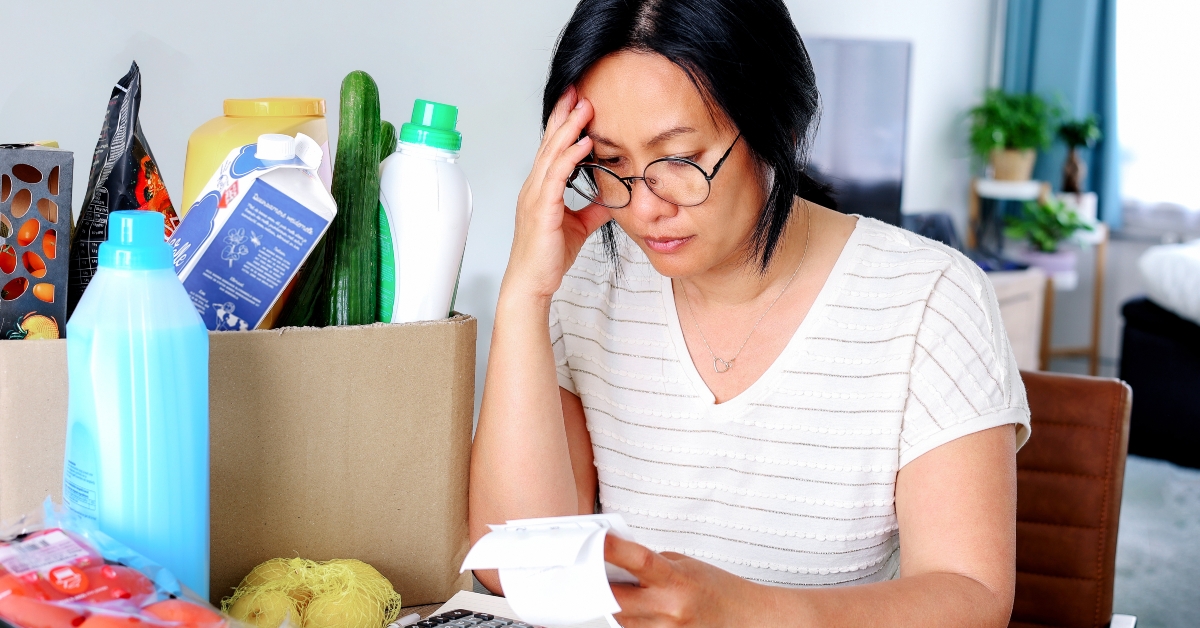 holding receipts from supermarket