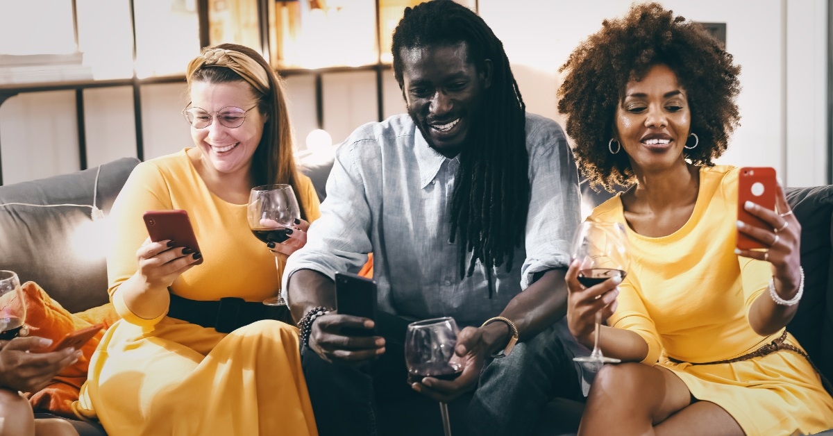 multi ethnic friends enjoying wine