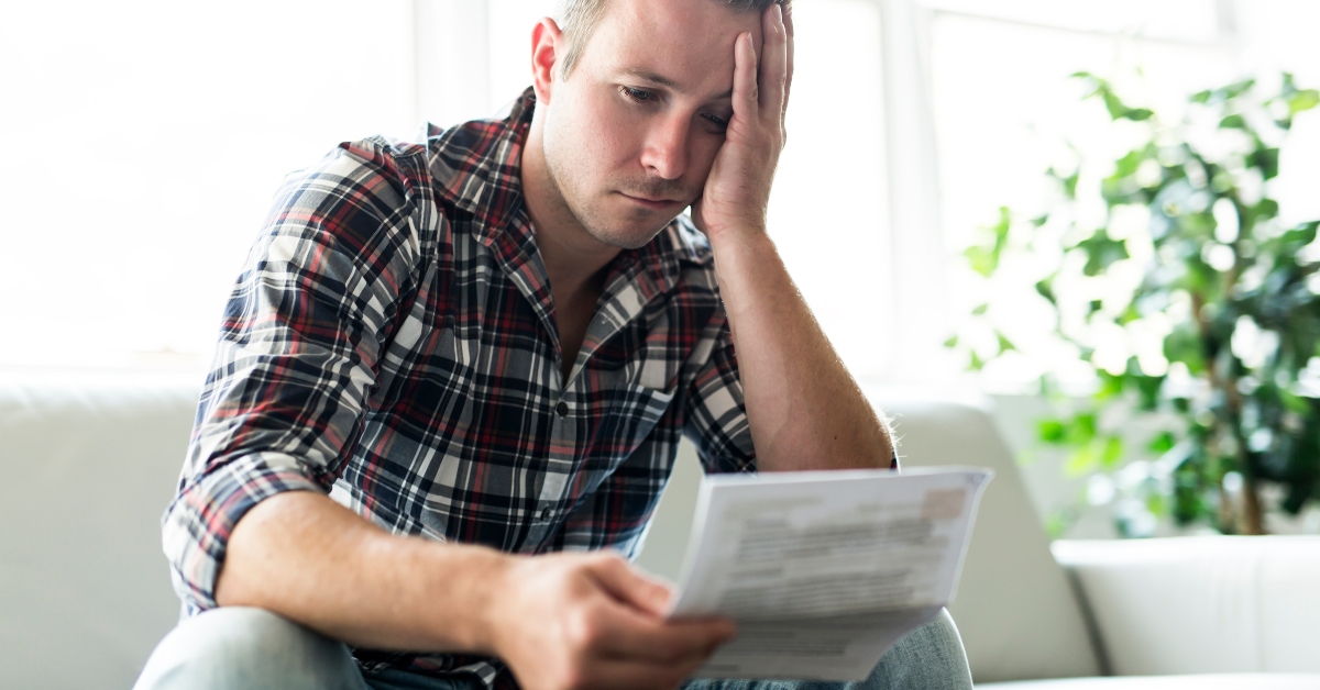 shocked man holding documents