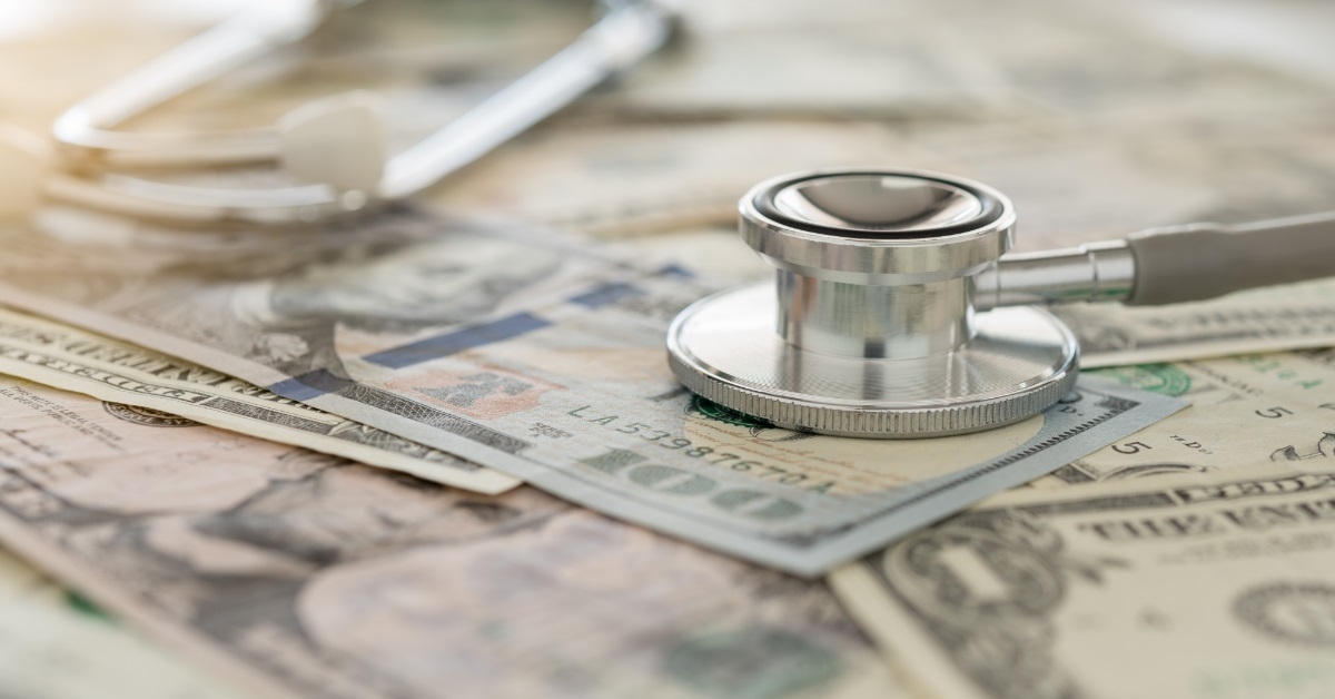 stethoscope on banknote medical cost concept