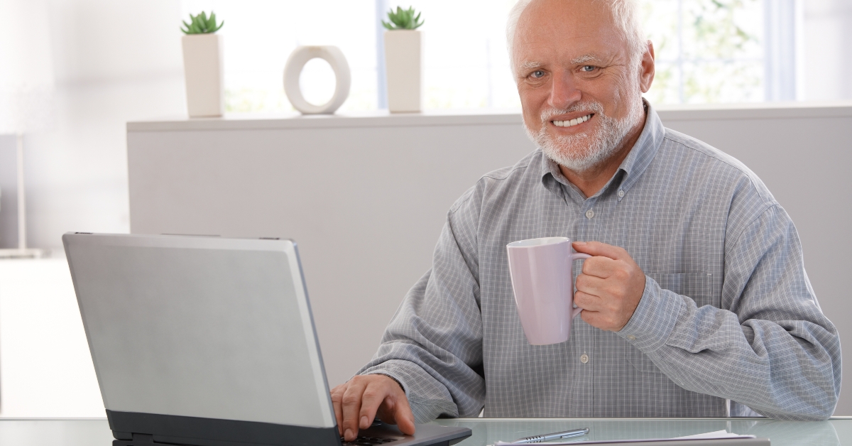 mature man with computer smiling