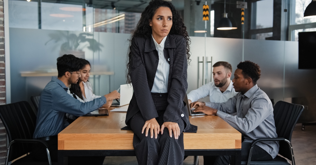 upset businesswoman sitting on table
