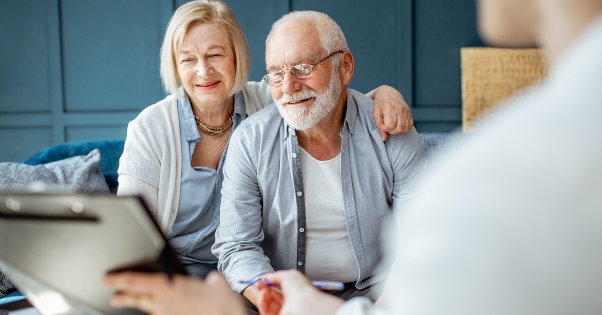 happy couple signing some agreement