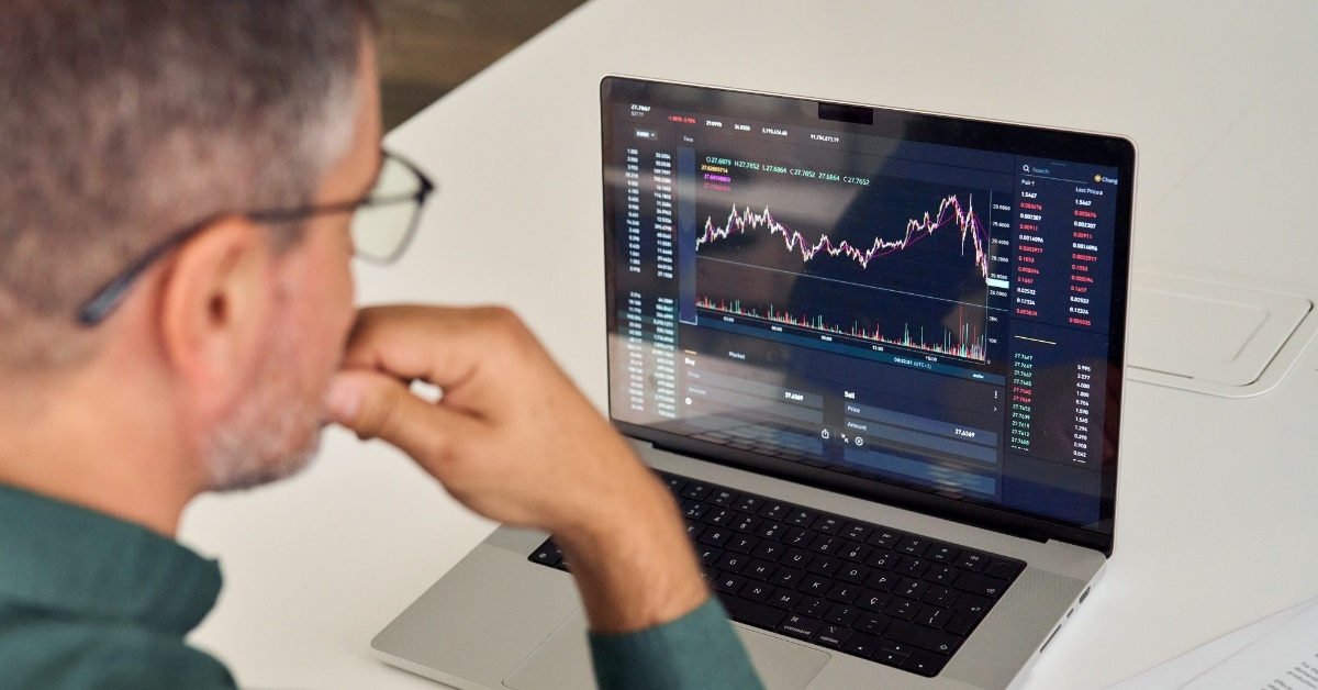 male broker analyzing stock market graphs