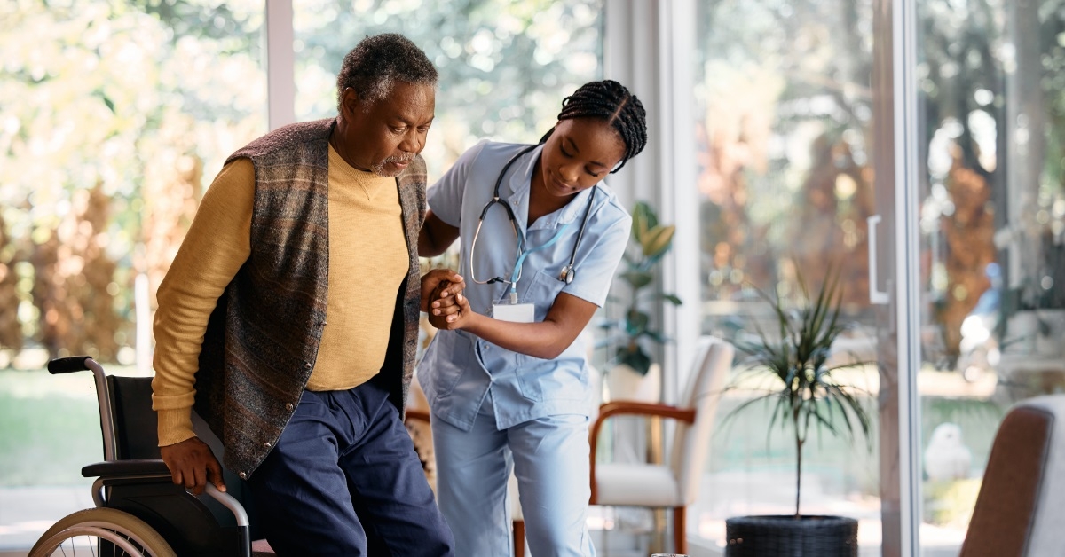 nurse assisting senior man on wheelchair