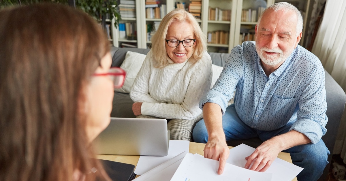 senior couple consulting female finance advisor