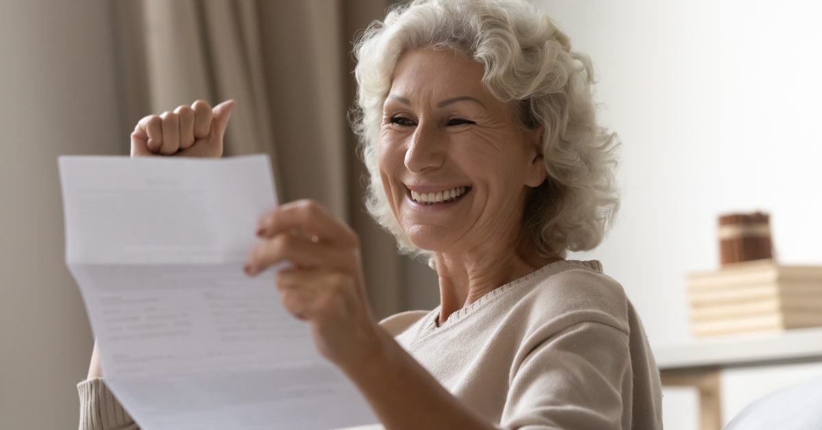 woman reading letter feels excited