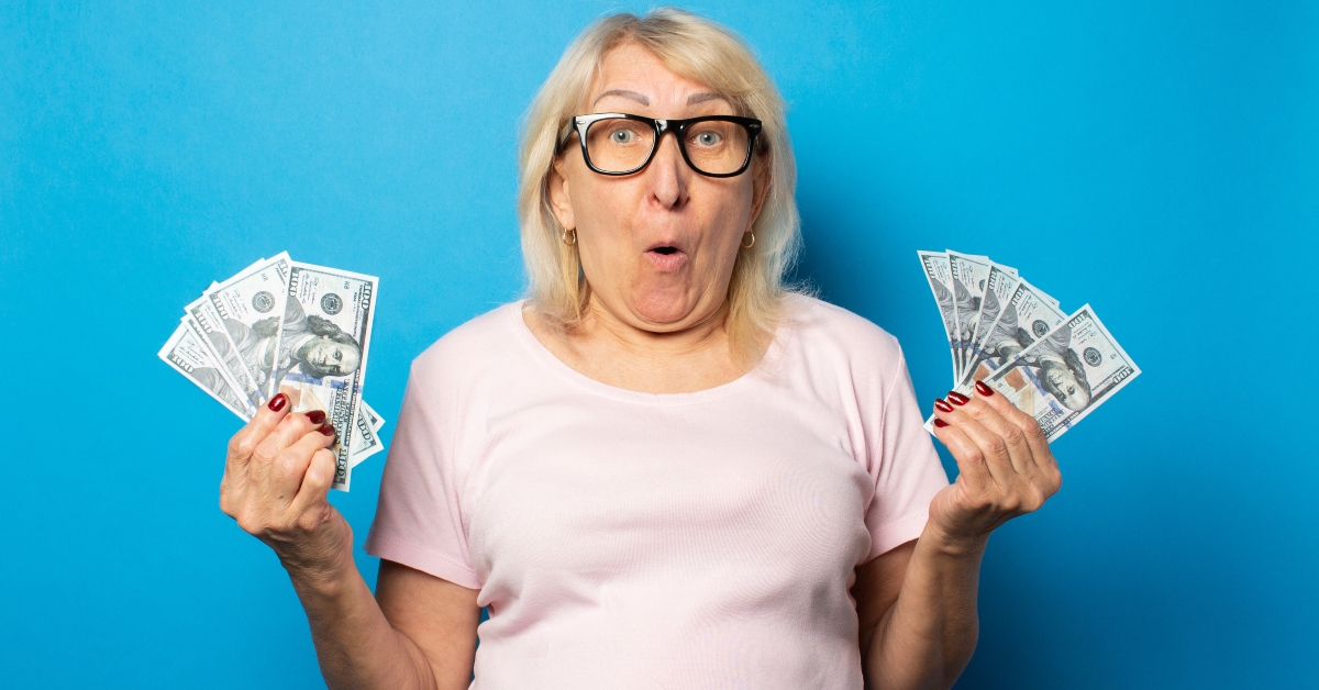 woman with glasses holding money