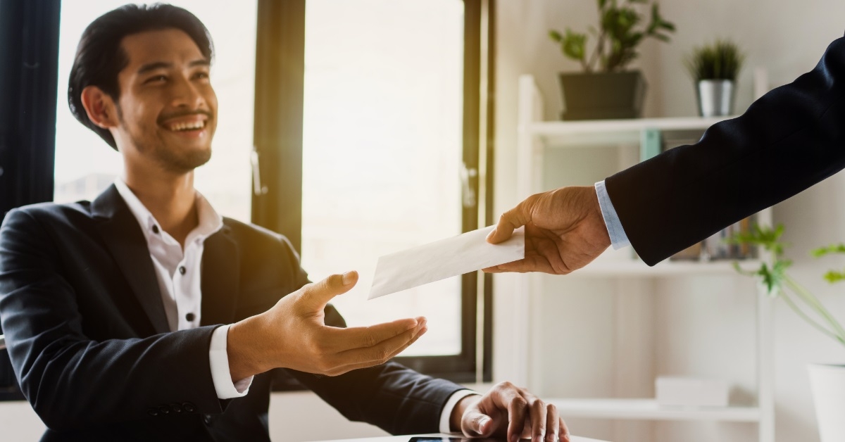 Businessman getting bonus from manager