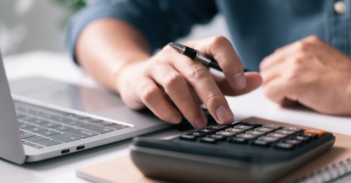 man calculating taxes using calculator