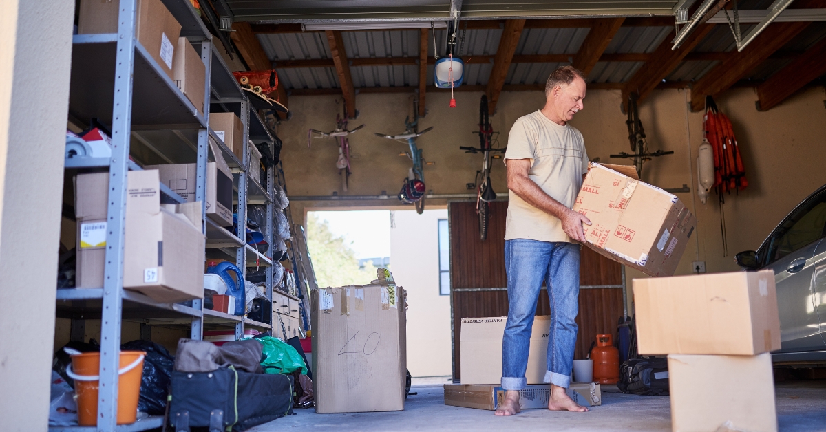 man carrying a box in a garage