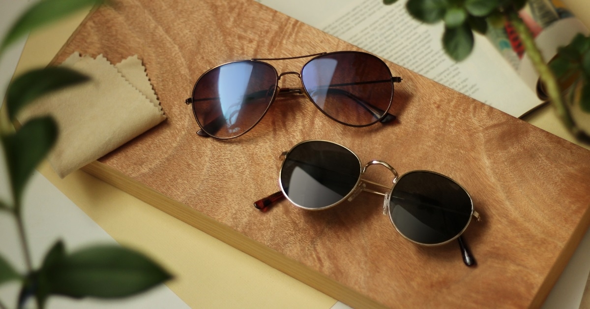 pairs of sunglasses on wooden board